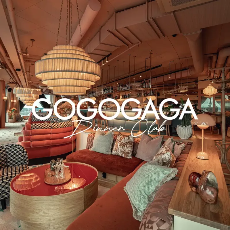 The Gogogaga Dinner Club lounge, with curved red velvet seating and layered pendant lights